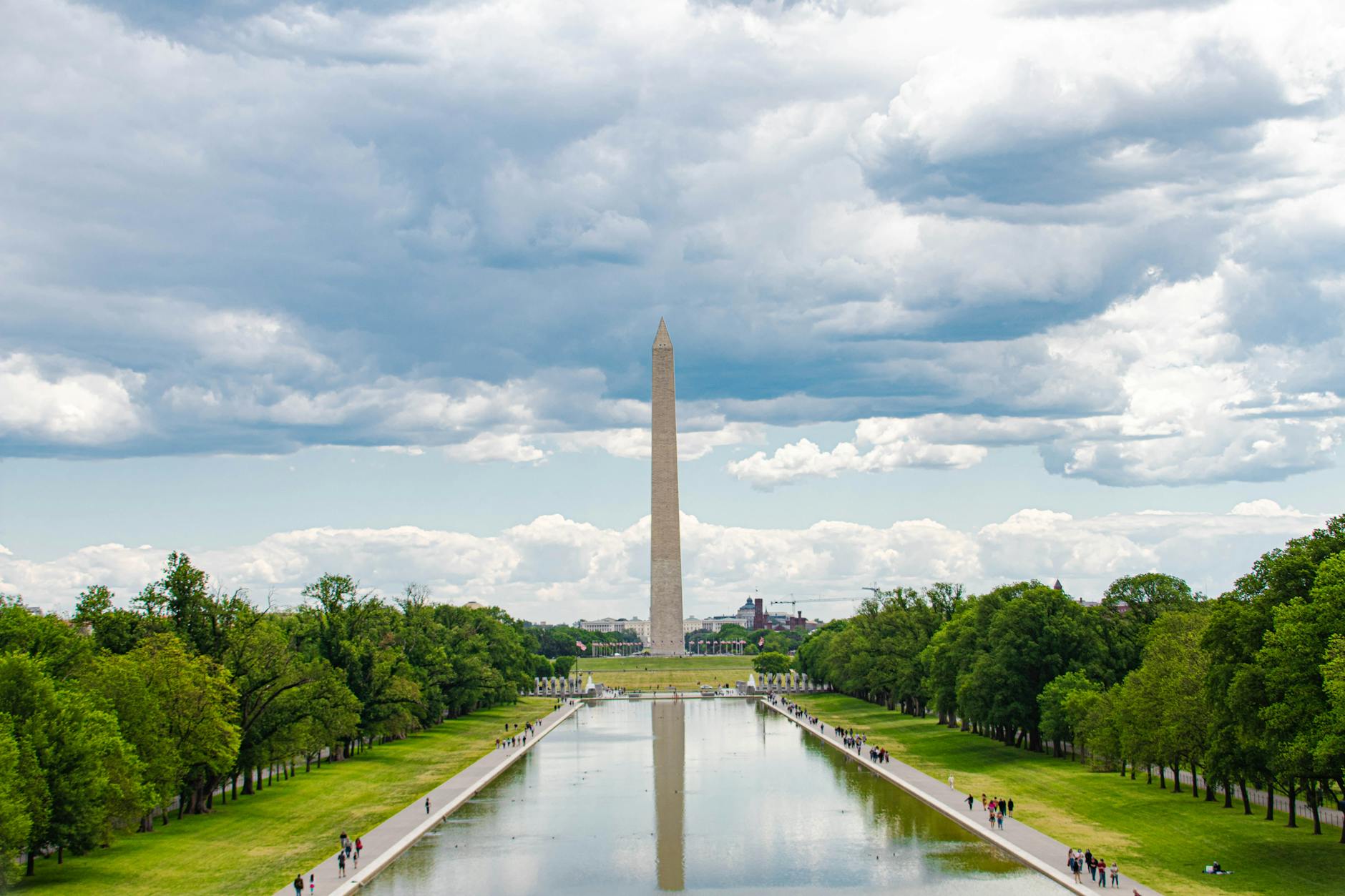 lincoln memorial reflecting pool with the washington monument under cloudy sky
