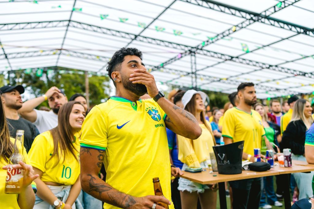 fans wearing yellow t shirts watching a match