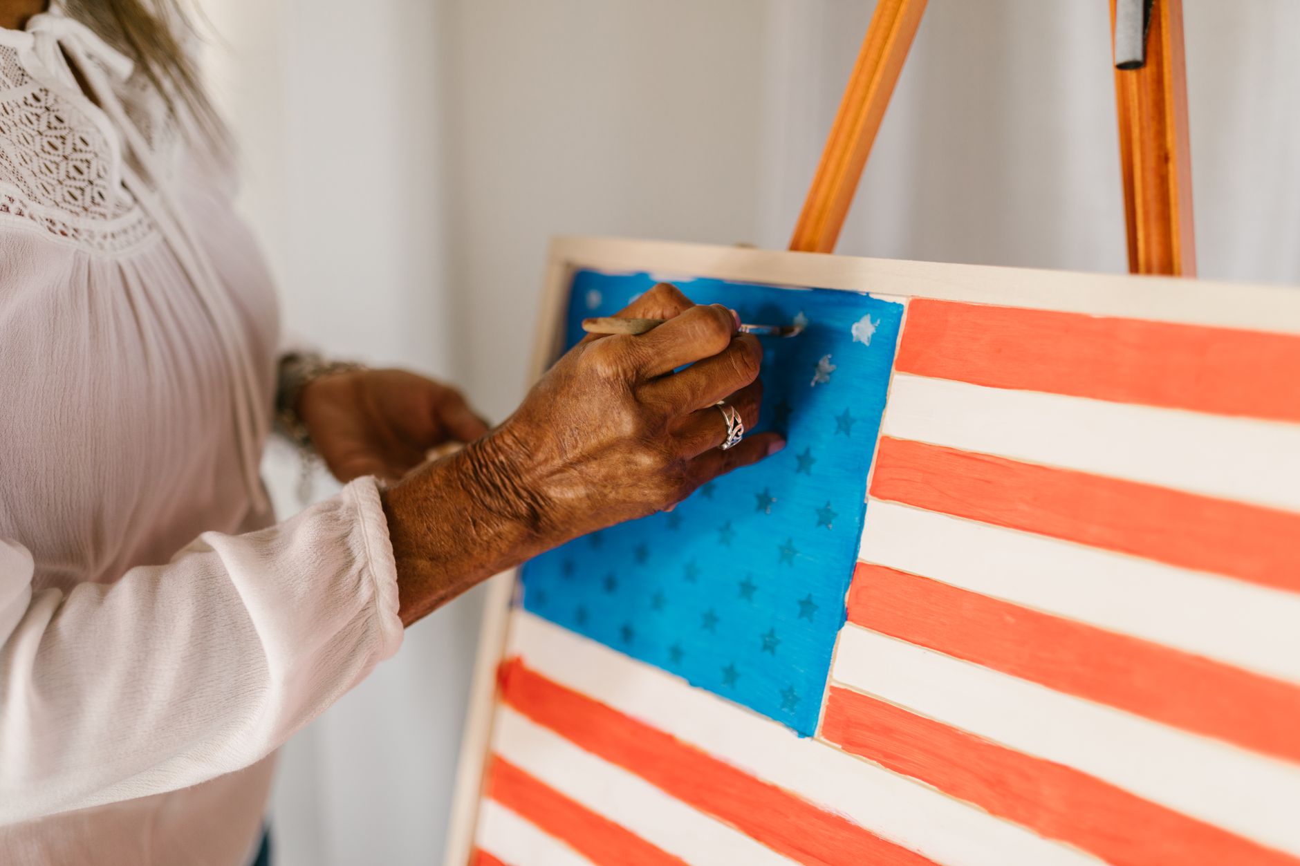 person painting an american flag using watercolor