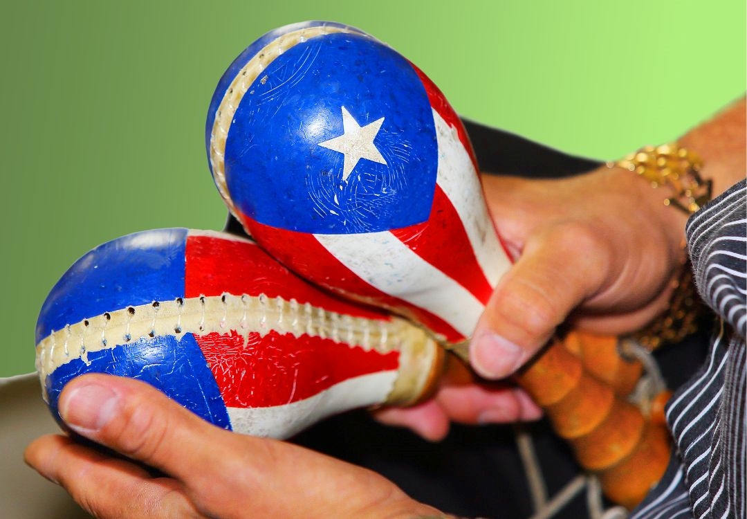 Hands holding a blue, red, and white baseball with a white star, representing the Puerto Rican flag.