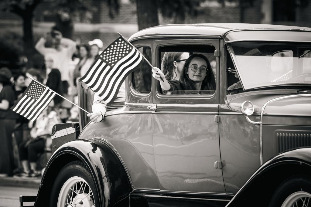 vintage car parade with american flags