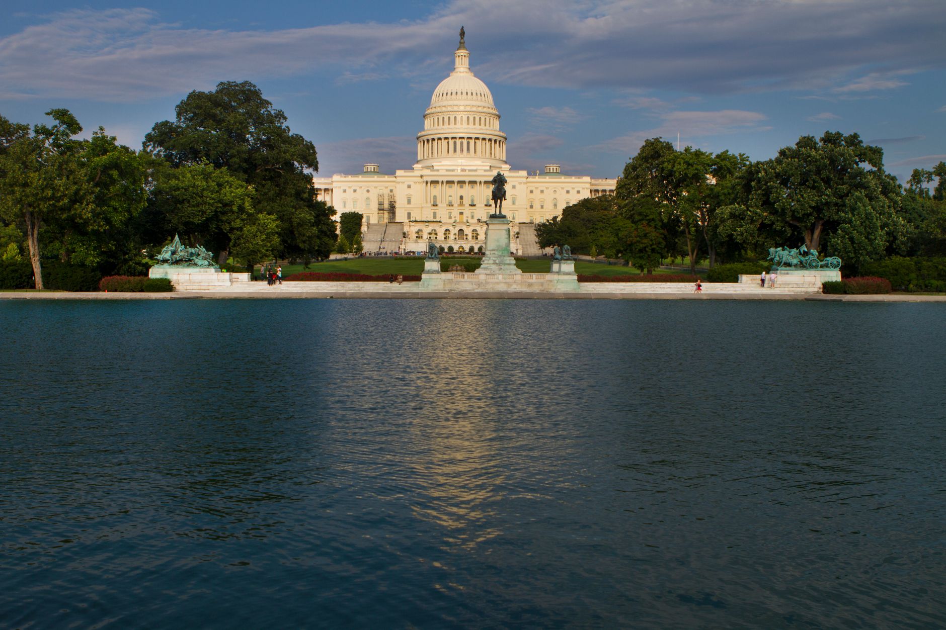 white dome building near green trees and body of water
