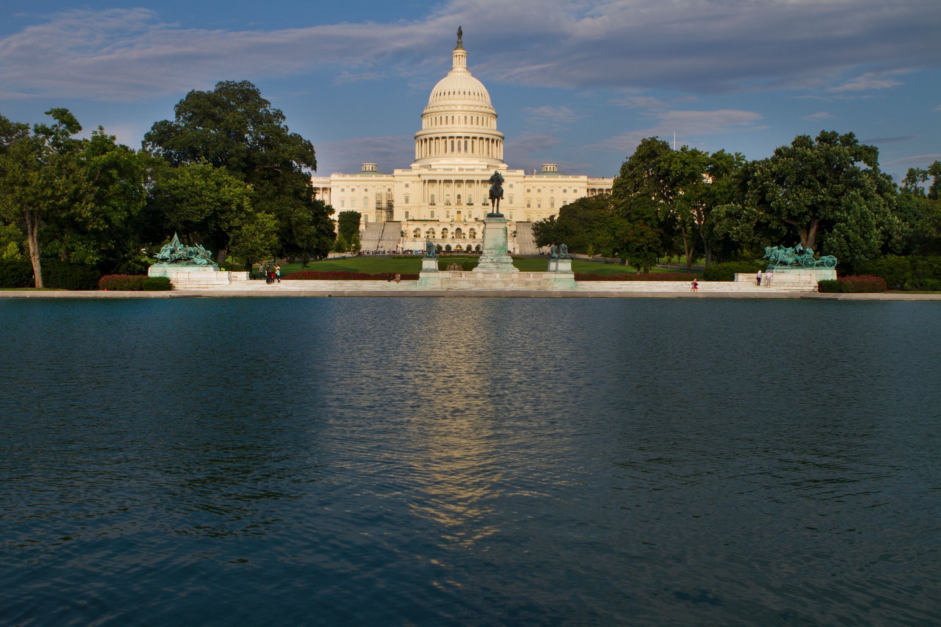 white dome building near green trees and body of water