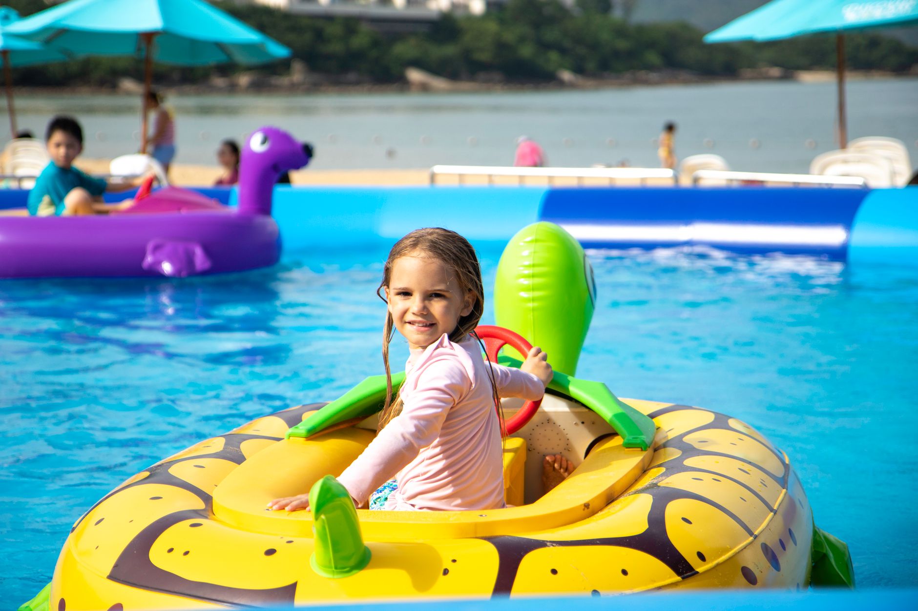 girl sitting on a floater floating on a swimming pool
