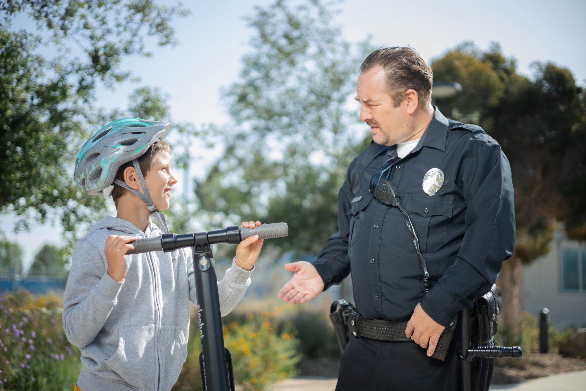 a boy talking to a police officer